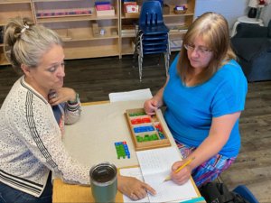 Two educators work through a worksheet together to better utilize the resources in their classrooms.