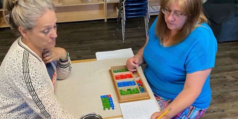 Two educators work through a worksheet together to better utilize the resources in their classrooms.
