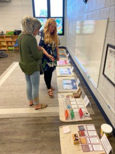 Two educators walk through a classroom, looking at all of the Montessori Resources at their disposal